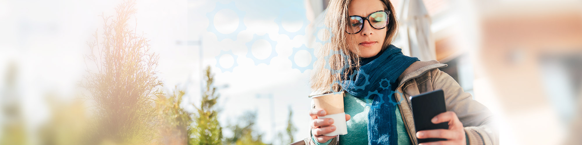 Woman looking at phone and drinking coffee